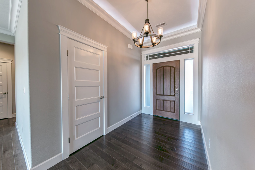 Entryway - mid-sized transitional medium tone wood floor entryway idea in Seattle with gray walls and a medium wood front door