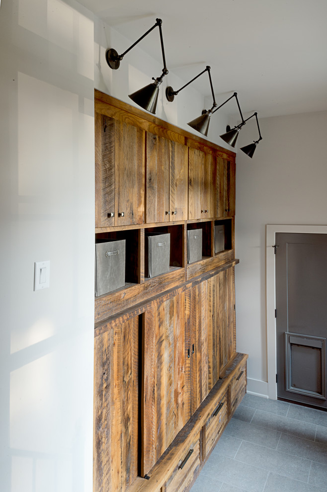 Mudroom - mid-sized transitional medium tone wood floor and brown floor mudroom idea in Other with white walls