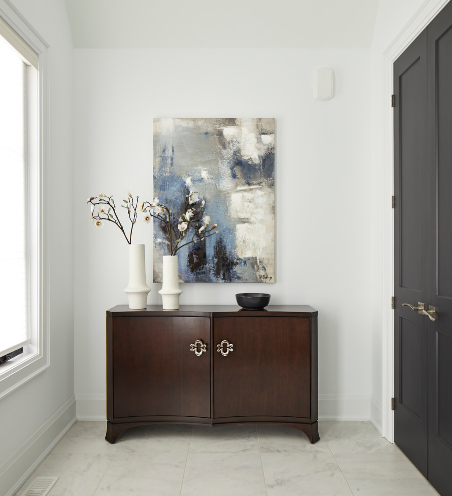 Mid-sized transitional porcelain tile and white floor entryway photo in Toronto with white walls