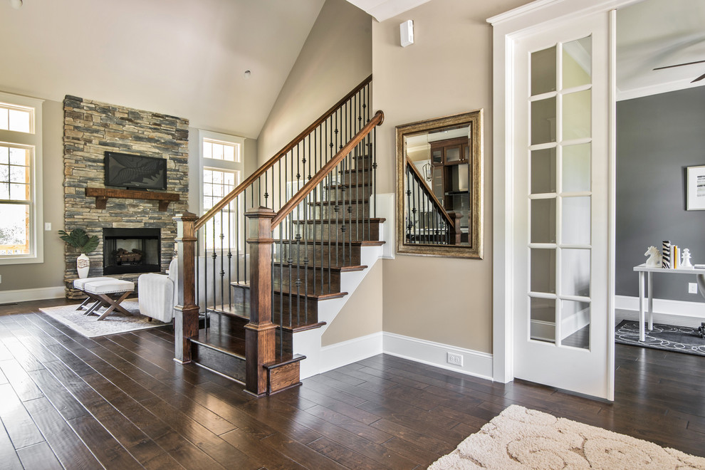 Mid-sized arts and crafts dark wood floor and brown floor foyer photo in Charlotte with beige walls