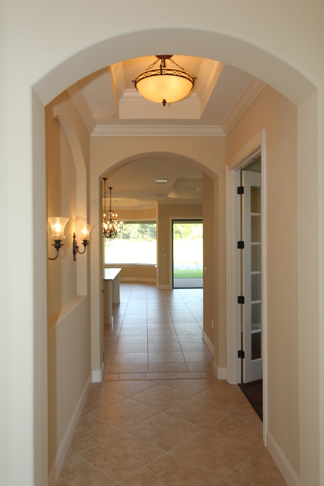 This is an example of a large classic foyer in Orlando with beige walls and ceramic flooring.