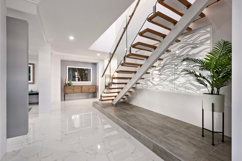 Inspiration for a large contemporary hallway in Perth with white walls, porcelain flooring, a single front door, a white front door and white floors.