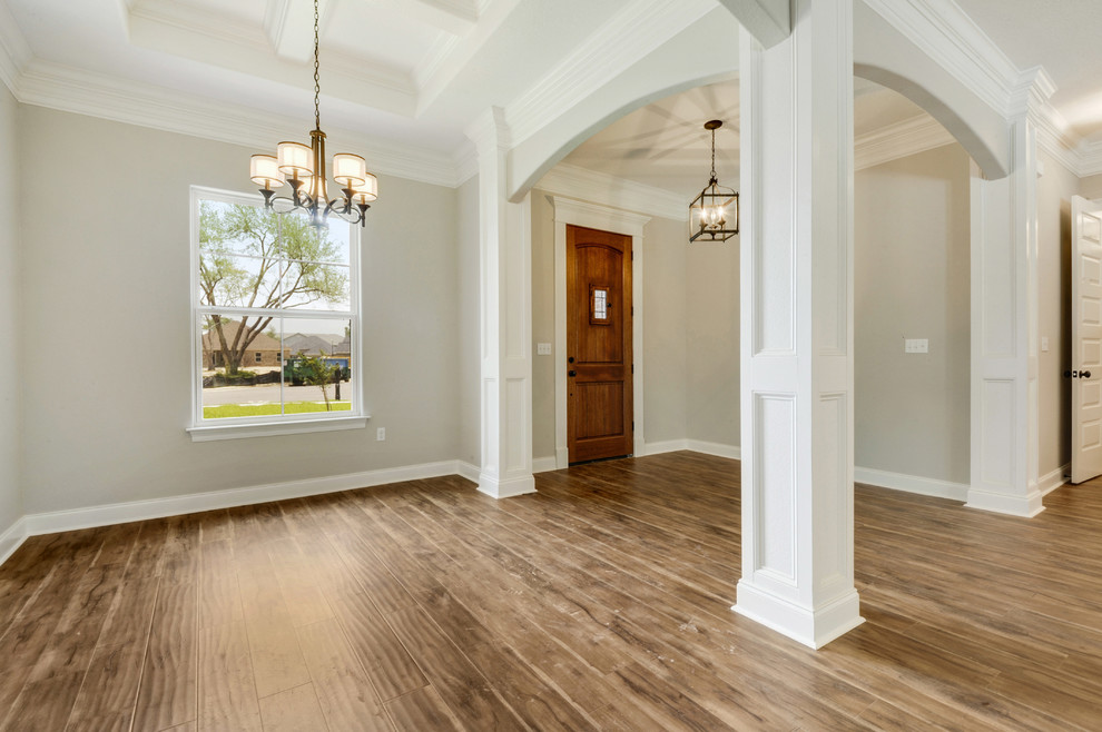 This is an example of a traditional foyer in Other with laminate floors and a single front door.