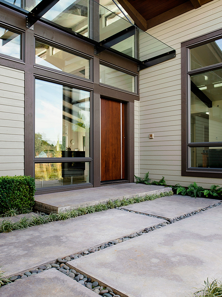 Inspiration for a contemporary entrance in Vancouver with a single front door and a dark wood front door.