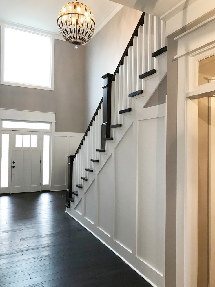This is an example of a farmhouse foyer in Other with dark hardwood flooring.