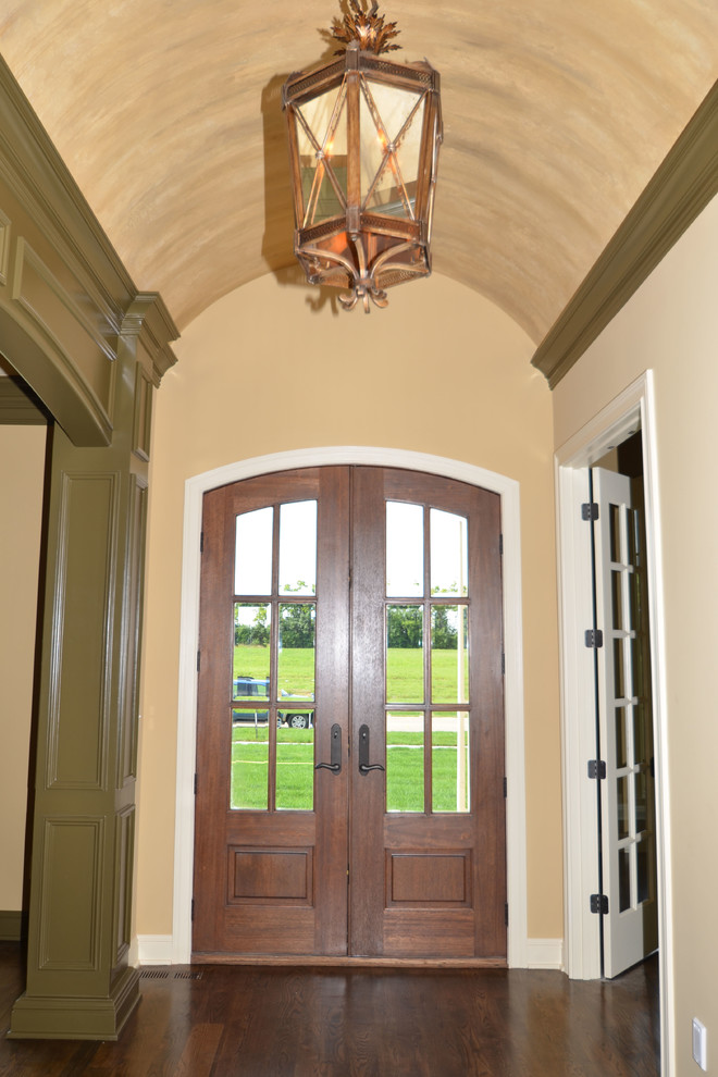 Large elegant dark wood floor entryway photo in Louisville with beige walls and a dark wood front door