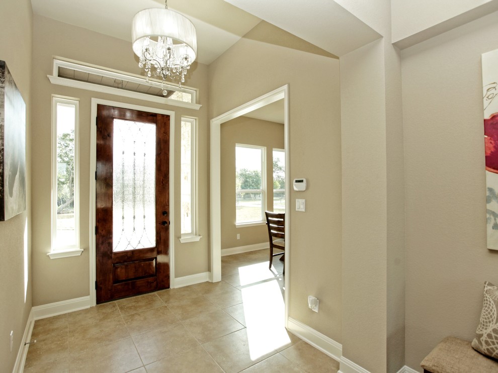 Small farmhouse porcelain tile entryway photo in Austin with beige walls and a medium wood front door