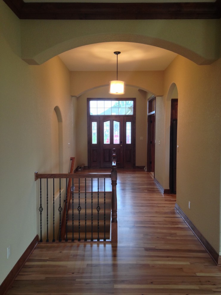 Exemple d'un hall d'entrée chic avec un mur beige, parquet clair et une porte simple.