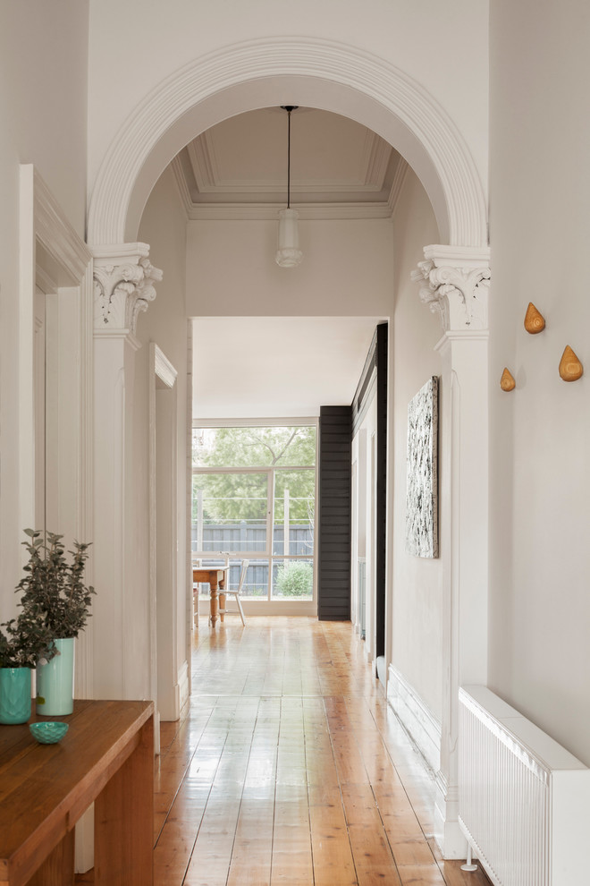 Источник вдохновения для домашнего уюта: узкая прихожая среднего размера в современном стиле с белыми стенами и светлым паркетным полом