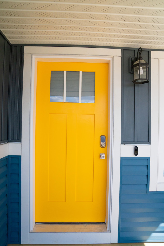 Foto på en liten amerikansk ingång och ytterdörr, med blå väggar, en enkeldörr och en gul dörr