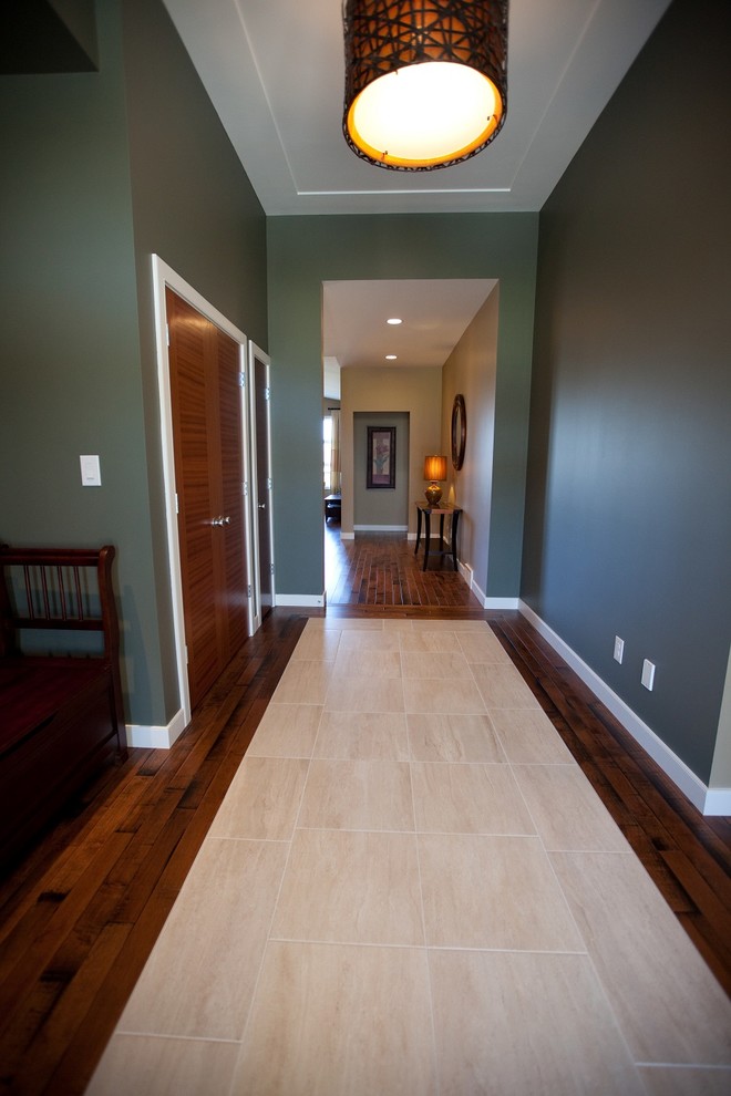 Large classic foyer in Other with green walls and porcelain flooring.