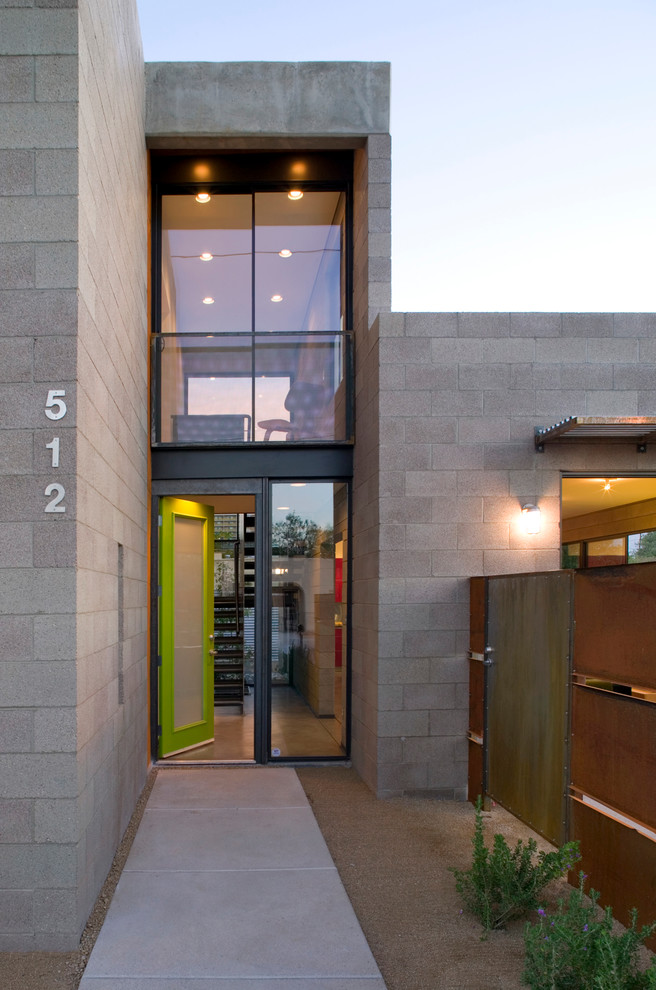 Ispirazione per una porta d'ingresso design con pavimento in cemento, una porta singola e una porta verde