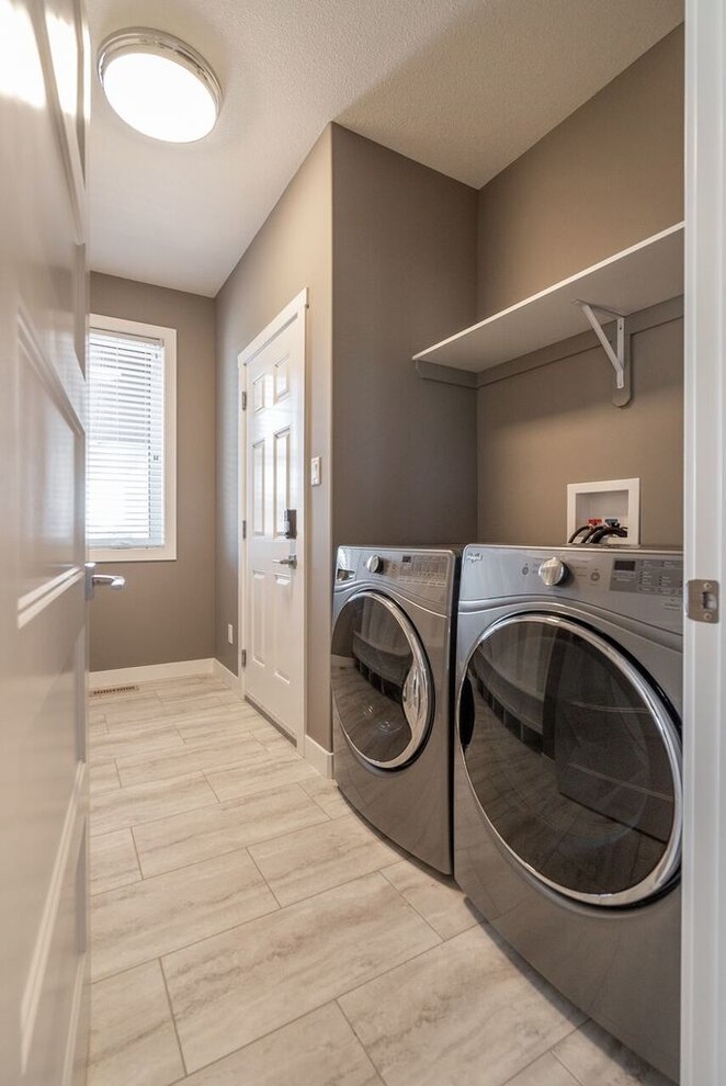 Photo of a classic utility room in Other with grey walls and grey floors.