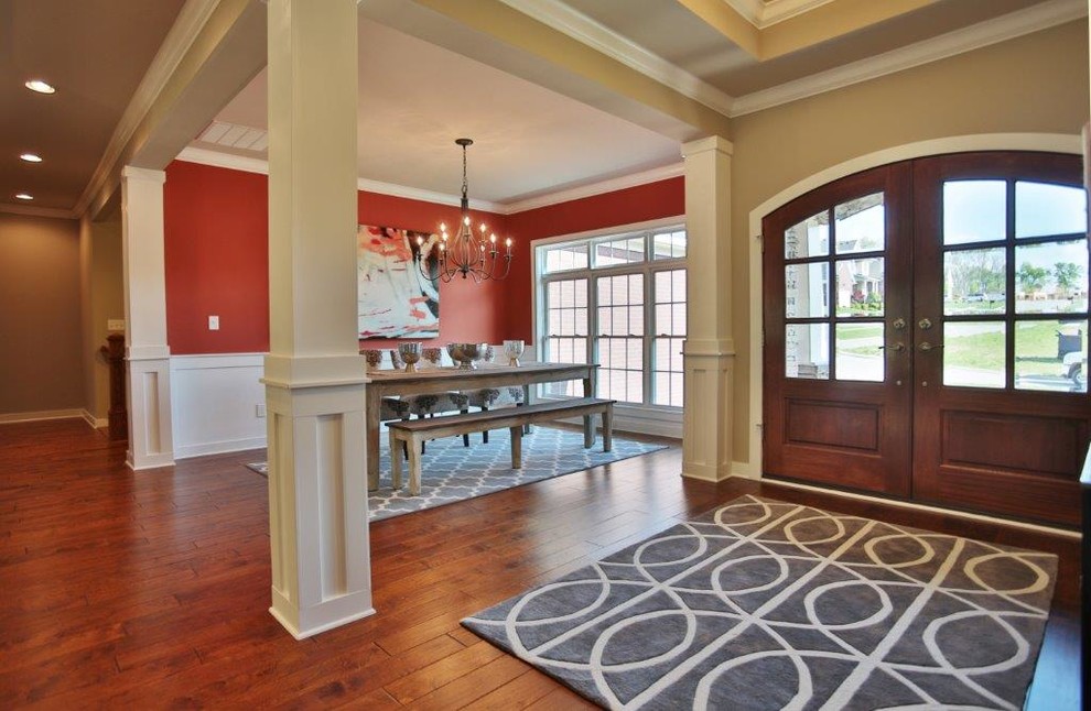 Entryway - mid-sized transitional dark wood floor entryway idea in Louisville with red walls and a medium wood front door