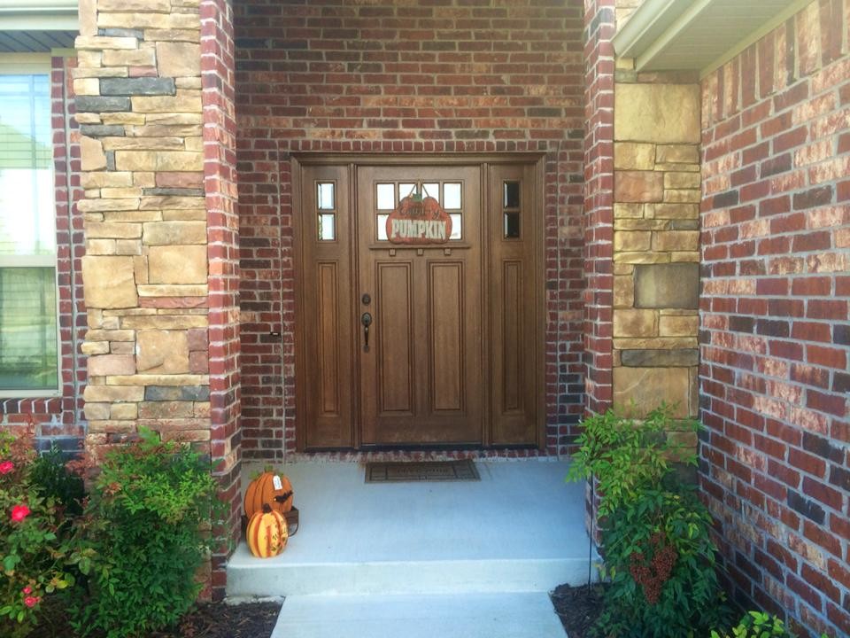 Inspiration for a large timeless entryway remodel in Dallas with a medium wood front door