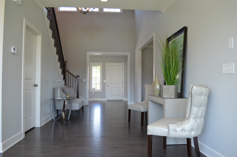 Inspiration for a large craftsman dark wood floor entryway remodel in Kansas City with white walls and a white front door
