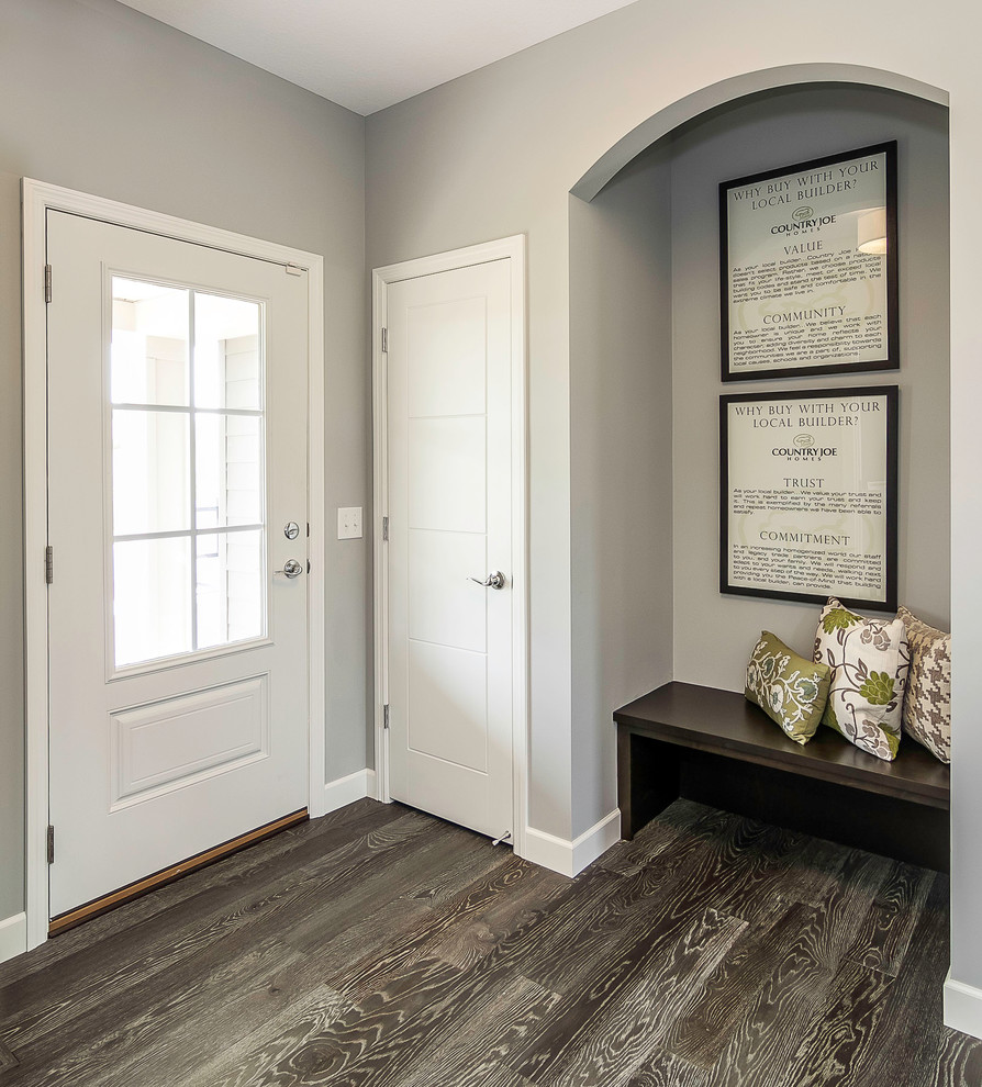 Inspiration for a mid-sized transitional dark wood floor entryway remodel in Minneapolis with gray walls and a white front door