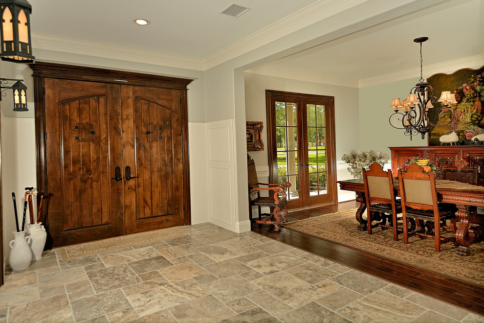 Mid-sized elegant travertine floor entryway photo in Phoenix with blue walls and a dark wood front door