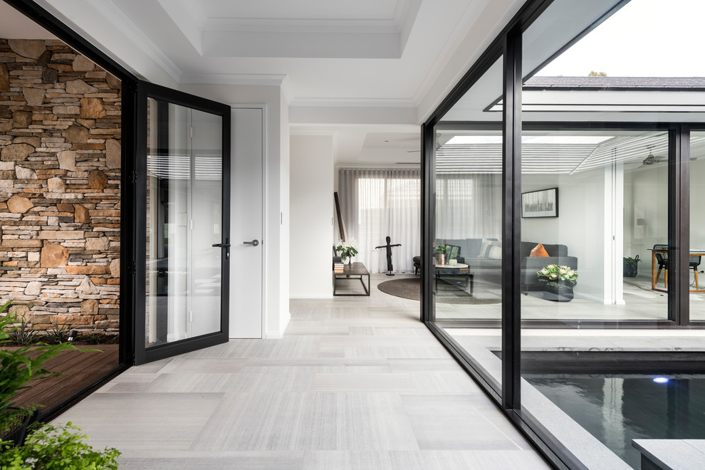 This is an example of a large contemporary front door in Perth with a double front door, a glass front door and grey floors.