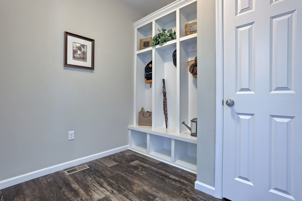 Inspiration for a mid-sized farmhouse vinyl floor mudroom remodel in Other with beige walls