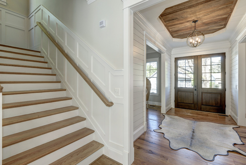 Inspiration for a large modern foyer in DC Metro with grey walls, light hardwood flooring, a double front door and a dark wood front door.