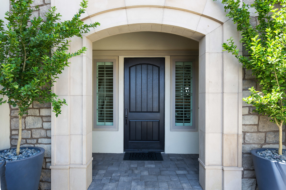Inspiration for a small traditional front door in Phoenix with beige walls, a single front door and a black front door.