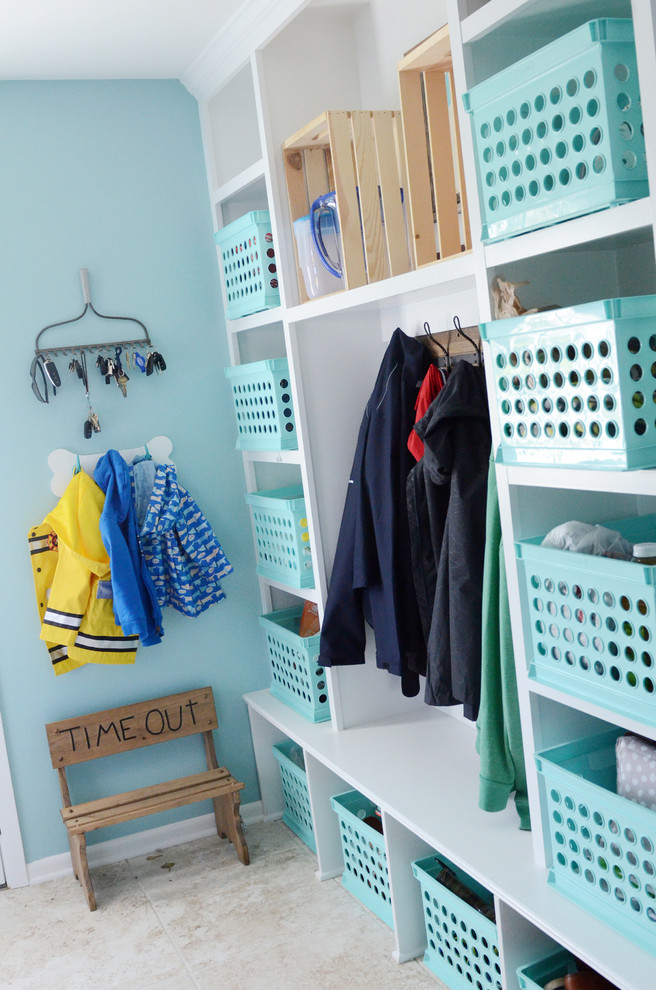 Example of a mid-sized transitional ceramic tile mudroom design in Columbus with blue walls