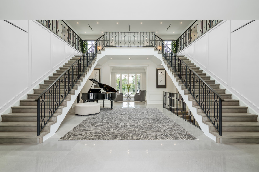 Photo of a traditional foyer in Los Angeles with white walls and grey floors.