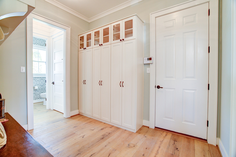 Example of a mid-sized cottage light wood floor and brown floor entryway design in Richmond with gray walls