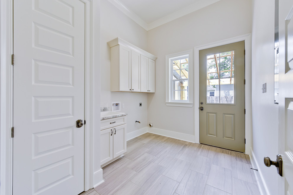 Mid-sized cottage porcelain tile and gray floor entryway photo in New Orleans with gray walls and a green front door