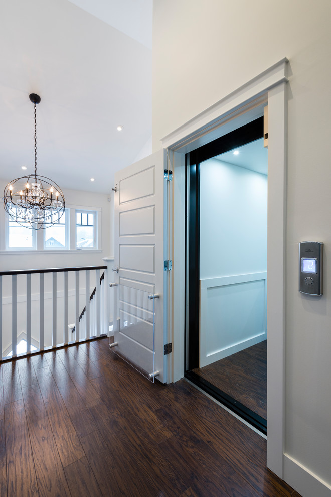 This is an example of a medium sized traditional front door in Vancouver with white walls, dark hardwood flooring, a single front door, a black front door and brown floors.