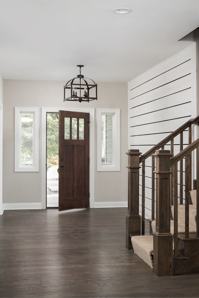 Inspiration for a medium sized country foyer in Chicago with beige walls, dark hardwood flooring, a single front door, a dark wood front door and brown floors.