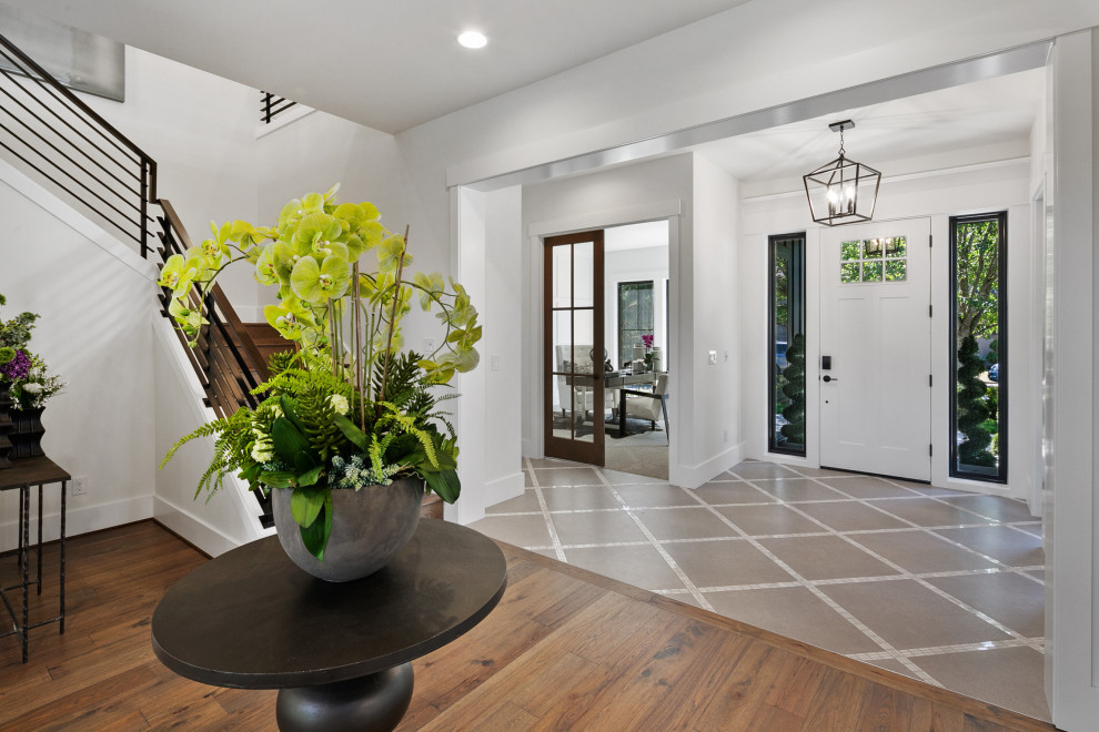 Large cottage medium tone wood floor and brown floor entryway photo in Seattle with gray walls and a white front door