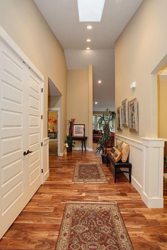Entry hall - mid-sized traditional dark wood floor entry hall idea in Portland with beige walls