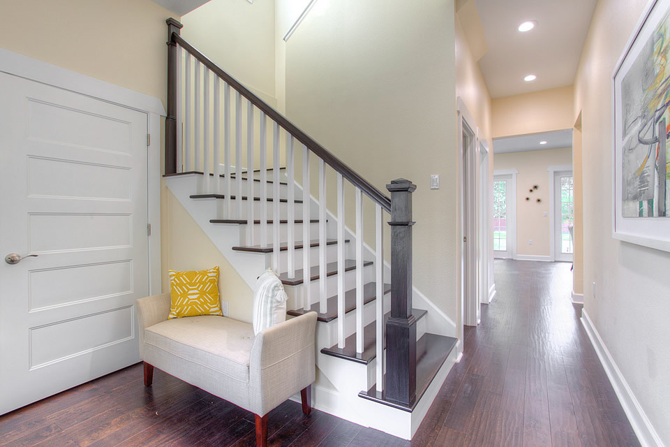 Inspiration for a mid-sized contemporary medium tone wood floor and brown floor entryway remodel in Tampa with beige walls and a white front door