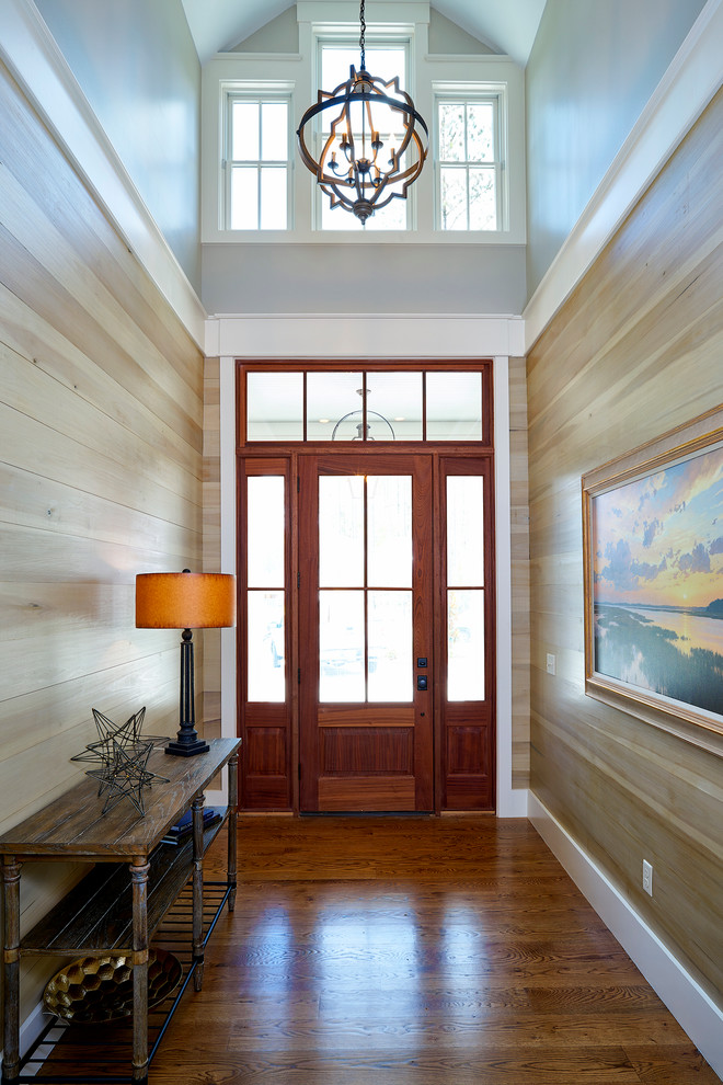 Inspiration for a medium sized classic hallway in Charleston with medium hardwood flooring, a medium wood front door, a single front door and feature lighting.