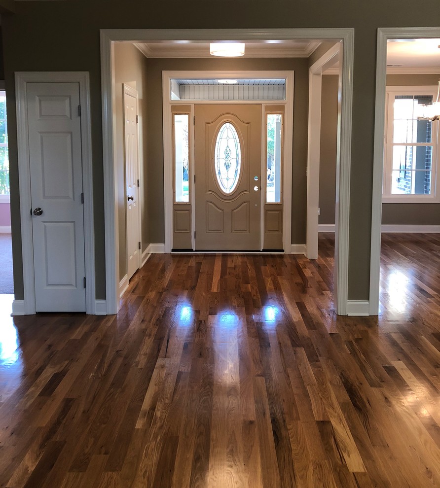 Medium sized traditional front door in Charlotte with brown walls, medium hardwood flooring, a single front door, a brown front door and brown floors.
