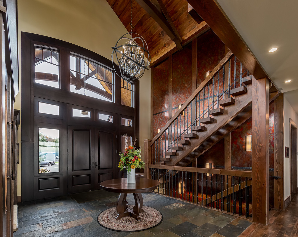 Photo of a large traditional foyer in Calgary with yellow walls, slate flooring, a double front door and a dark wood front door.