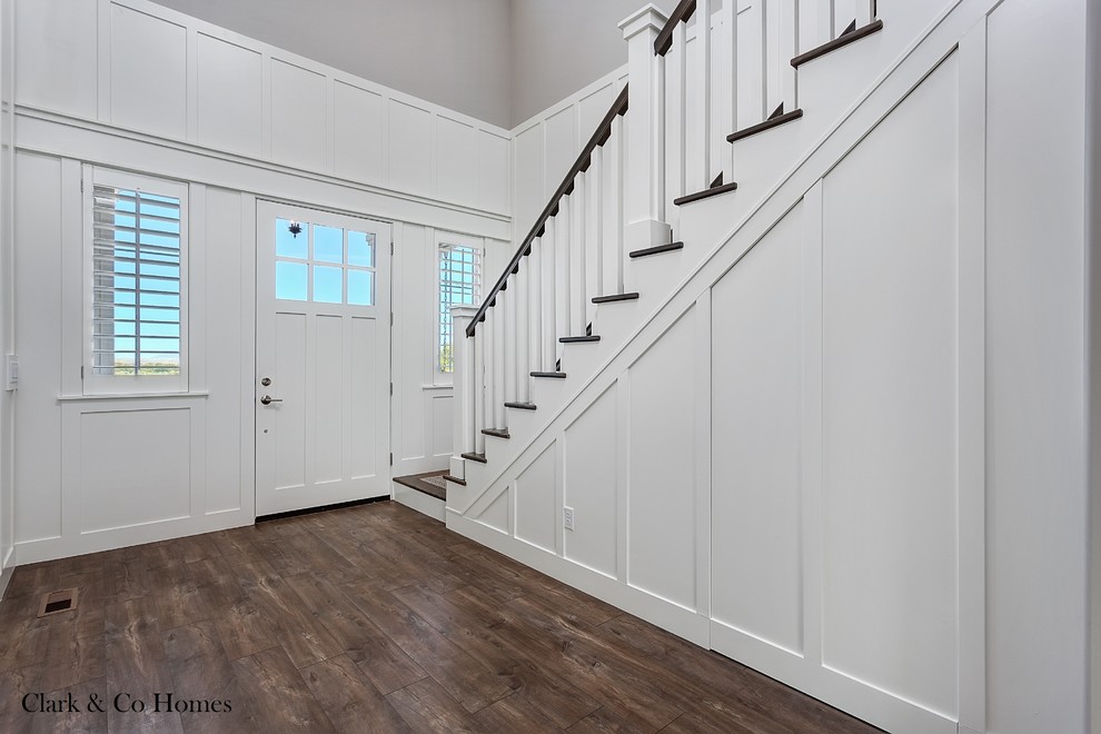 Large country foyer in Boise with grey walls, dark hardwood flooring, a single front door and a white front door.