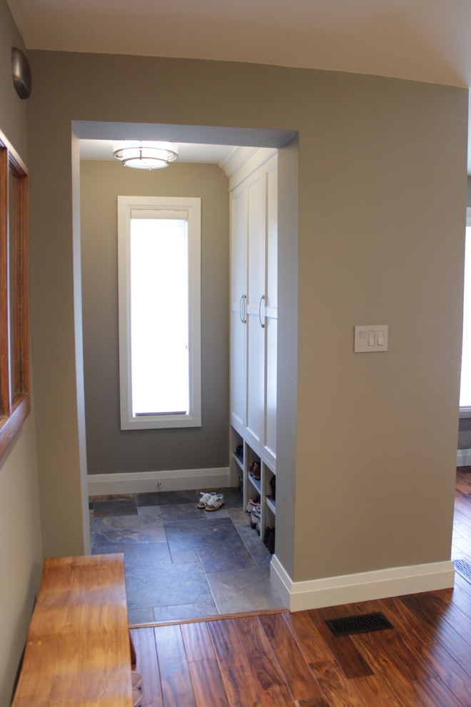 Entryway - small transitional slate floor entryway idea in Toronto with brown walls and a dark wood front door