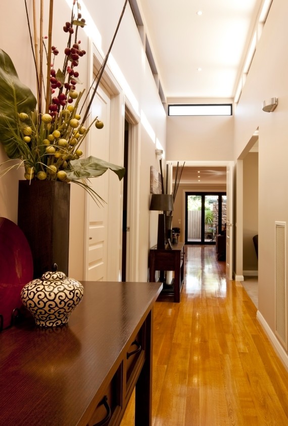 Example of a large transitional medium tone wood floor entryway design in New York with beige walls and a medium wood front door