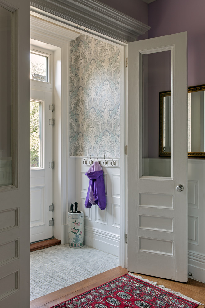 На фото: прихожая в стиле неоклассика (современная классика) с фиолетовыми стенами, полом из керамогранита, двустворчатой входной дверью, белой входной дверью и серым полом с
