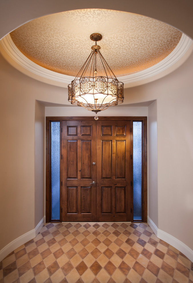 Example of a large classic entryway design in Phoenix with beige walls and a medium wood front door