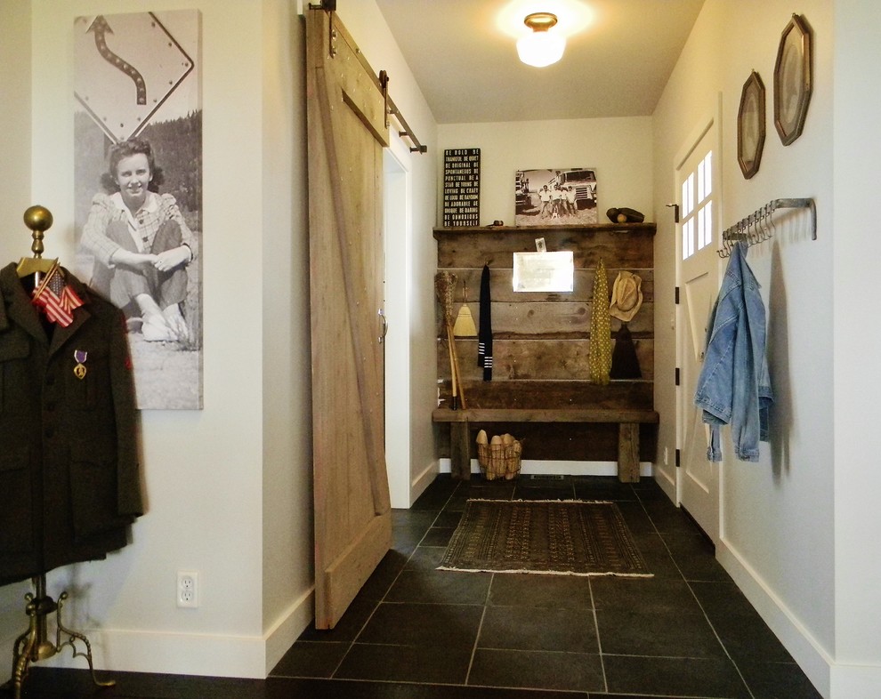 Example of a mid-sized country slate floor entryway design in Seattle with beige walls