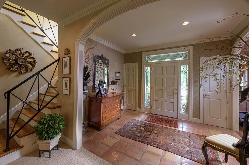 Entryway - mid-sized traditional ceramic tile entryway idea in Louisville with beige walls and a white front door