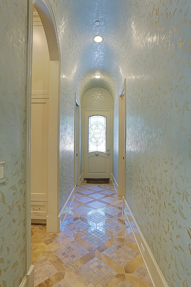Example of a large classic granite floor entryway design in Houston with beige walls and a white front door