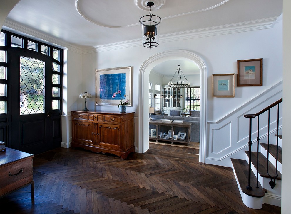Inspiration for a medium sized classic foyer in Phoenix with white walls, dark hardwood flooring, a single front door and feature lighting.