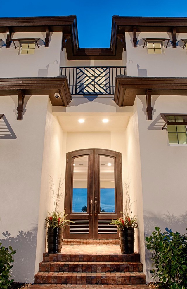 Inspiration for a large traditional front door in Miami with a double front door and a metal front door.