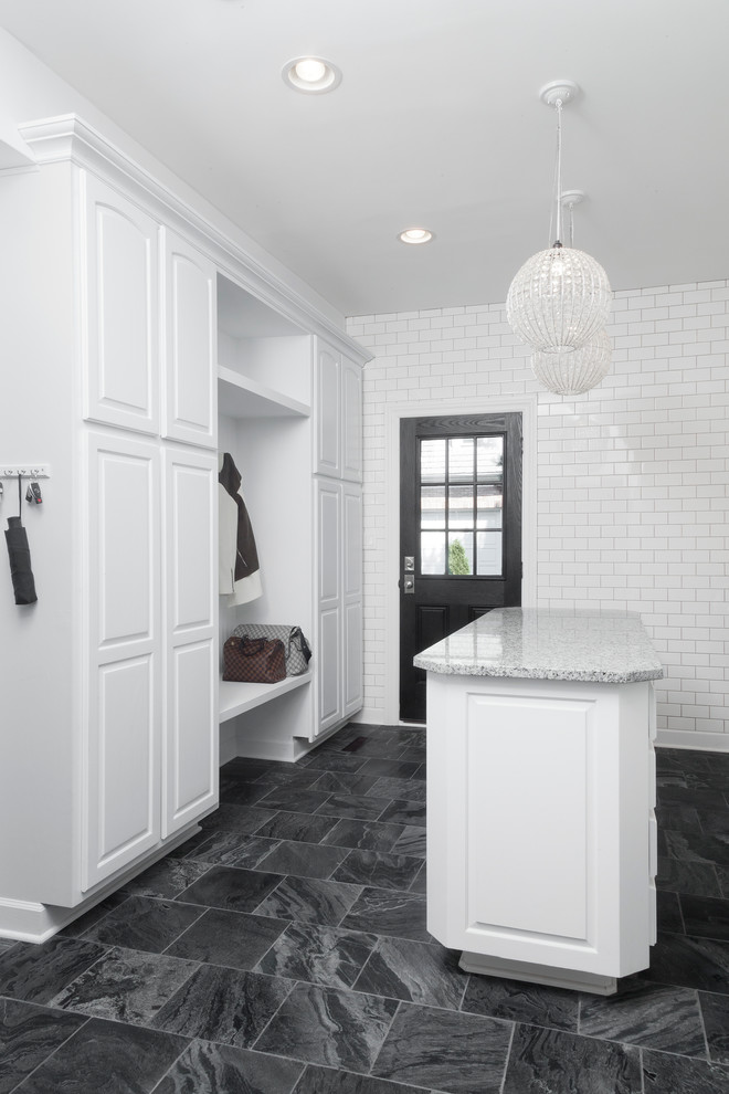 Large traditional boot room in Chicago with white walls, ceramic flooring, a single front door, a black front door and grey floors.