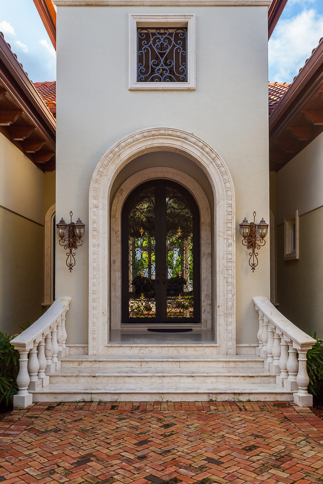 This is an example of a large mediterranean front door in Miami.